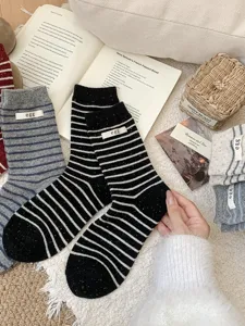 Cozy striped wool knit socks with cute fabric labels, designed for comfortable daily winter wear.