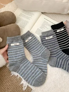 Cozy women wool socks with striped design and cute egg label, winter warm mid tube socks.