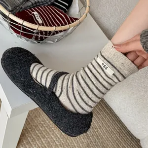Women striped wool socks with fabric label, stylish mid-tube casual cozy hosiery main view.
