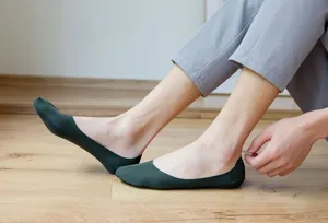 Detail view of men's low-cut invisible boat socks in dark green, smooth ice silk fabric.