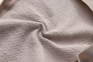 Detailed close-up view of breathable knit fabric texture with soft terry loop bottom.