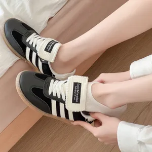 Detailed view of classic black and white casual sneakers with low profile and good comfort.