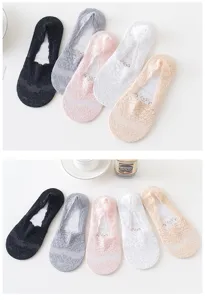 Detailed view of floral lace no-show socks with non-slip silicone, breathable cotton sole.