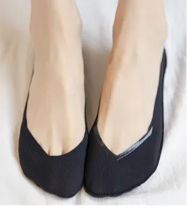 Close-up detail shot of women's black low-cut invisible socks featuring anti-slip silicone.
