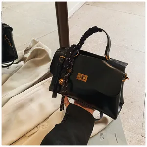 Stylish minimalist black crossbody bag for women, chic square handbag with scarf detail.