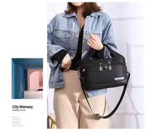 Detailed view of black nylon shoulder bag showing fine craftsmanship, zippers and metal hardware.