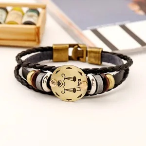 Pulsera de cuero trenzado vintage para hombre con dije de metal del signo Libra.