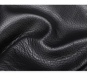 Premium black genuine cowhide leather texture close-up detail for men's chest sling bag.