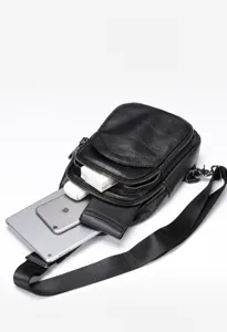 Detail view of the men's leather chest bag showing spacious interior and multiple compartments.