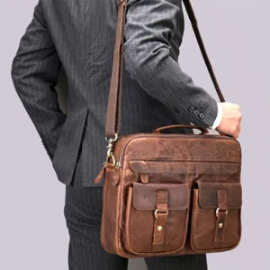 Vue détaillée d'un sac messager en cuir vintage avec poches avant et quincaillerie en métal.