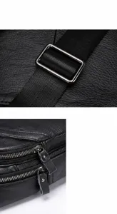 Detailed shot of men's leather chest bag strap buckle and smooth metal zippers.