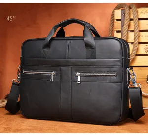 Détail de mallette d'affaires en cuir noir avec fermetures éclair métalliques et poignées.