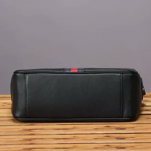 Black genuine leather men's shoulder bag detail close-up, casual messenger design.