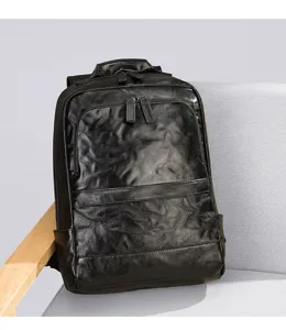 Close-up view of the black crinkled leather backpack showcasing its premium texture.