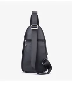 Detailed view of black leather chest bag, premium cowhide texture, adjustable strap.