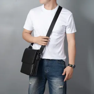 Detailed close-up view of the black genuine leather men's shoulder bag worn by model.