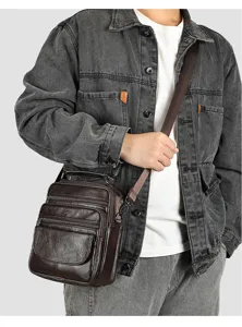 Close-up detail of multi-pocket genuine leather men's crossbody shoulder bag in dark brown.
