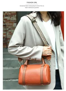 Genuine leather women barrel shoulder bag with wide strap and handbag handle for daily use.