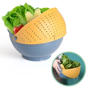 Double layer rotating plastic kitchen colander and draining basket for washing fruits and vegetables.