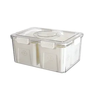 Boîte de rangement transparente pour réfrigérateur avec paniers de drainage intérieurs.