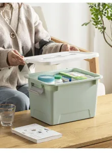 Plastic storage box with lid, green household container for dormitory or desktop organizer.