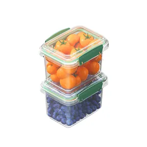 Transparent sealed food storage containers with green lids for refrigerator fruit and vegetable use.