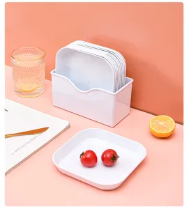 Detailed shot of white square plastic plate set with storage box in a neat home setting.