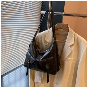 Retro motorcycle black leather backpack women, casual commuting multi-pocket shoulder bag detail.