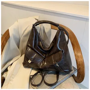 Retro brown leather motorcycle shoulder bag for women, casual tote with front pockets.