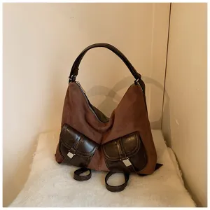 Detailed view of the brown retro vintage casual backpack with dual front pockets and straps.