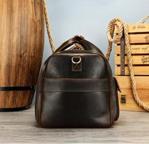 Detailed view of men's genuine crazy horse leather travel duffel bag, vintage style.