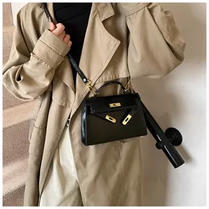 Élégant sac Kelly en cuir vernis noir, sac à bandoulière vintage pour femme chic or.