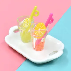 Close-up detail of miniature resin fruit smoothie cups on a tray with pastel background