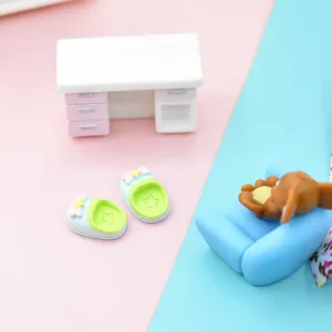 Close-up of cute miniature resin slippers with star detail for DIY dollhouse crafts