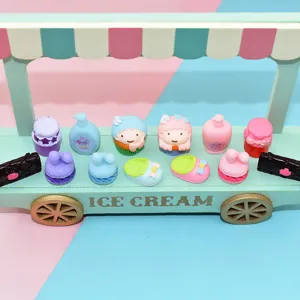 Miniature cartoon resin charms of Little Twin Stars characters on a mint green toy cart