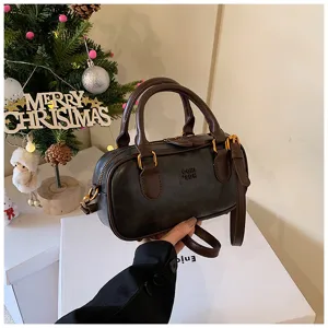 Retro brown bowling handbag with top handle and shoulder strap for women casual daily wear.