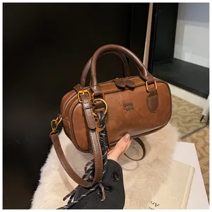 Retro brown bowling bag detail, PU leather texture, metal hardware close-up, stylish strap.