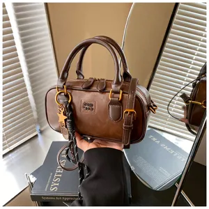 Retro casual brown leather bowling bag, stylish portable shoulder and crossbody bag for women.