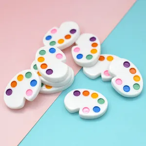 Detailed macro view of colorful miniature resin painter palette charms for creative DIY crafts