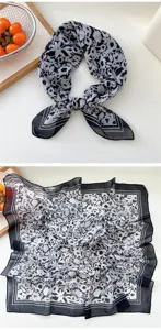 Close-up detail of the black and white floral square scarf, showing delicate fabric and chic print.