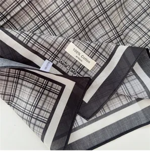 Detail shot of the vintage plaid cotton small square scarf, showing fabric texture and neat label.