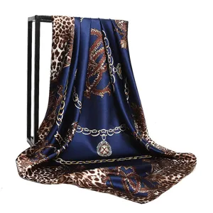 Detail view of women silk square scarf featuring elegant leopard print and chain motifs. 90x90