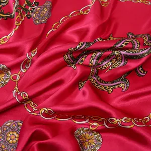 Luxurious pink satin silk scarf featuring bold baroque gold chains and leopard print design.