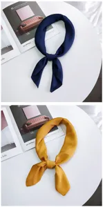 Silk square scarf detail view, solid navy and yellow color, smooth fabric texture.