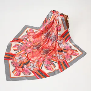 Elegant square silk scarf featuring vibrant orange floral and chain patterns, perfect accessory.