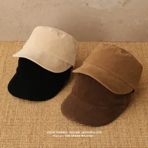 Detailed view of autumn winter suede flat top newsboy caps in multi colors, soft texture.