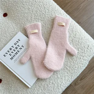 Pink knitted winter mittens cozy warm soft fleece fabric thick woolen gloves detail shot product view
