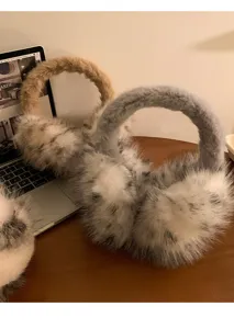 Fluffy plush earmuffs detail view, soft winter warm ear warmer, cozy fuzzy texture accessory.