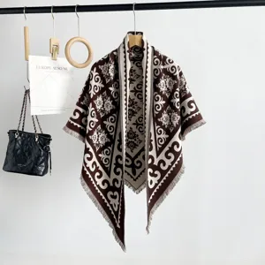 Detailed view of women geometric jacquard knit shawl cape with fringe, elegant vintage design.
