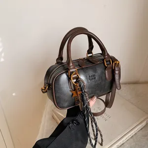 Vintage brown bowling shoulder bag for women, retro PU leather handbag with chic star charm.